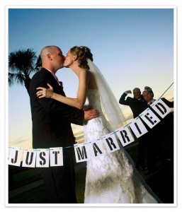 A "JUST MARRIED" newlywed couple kissing!