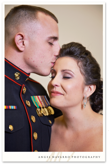 Military brother kisses sister on forehead.