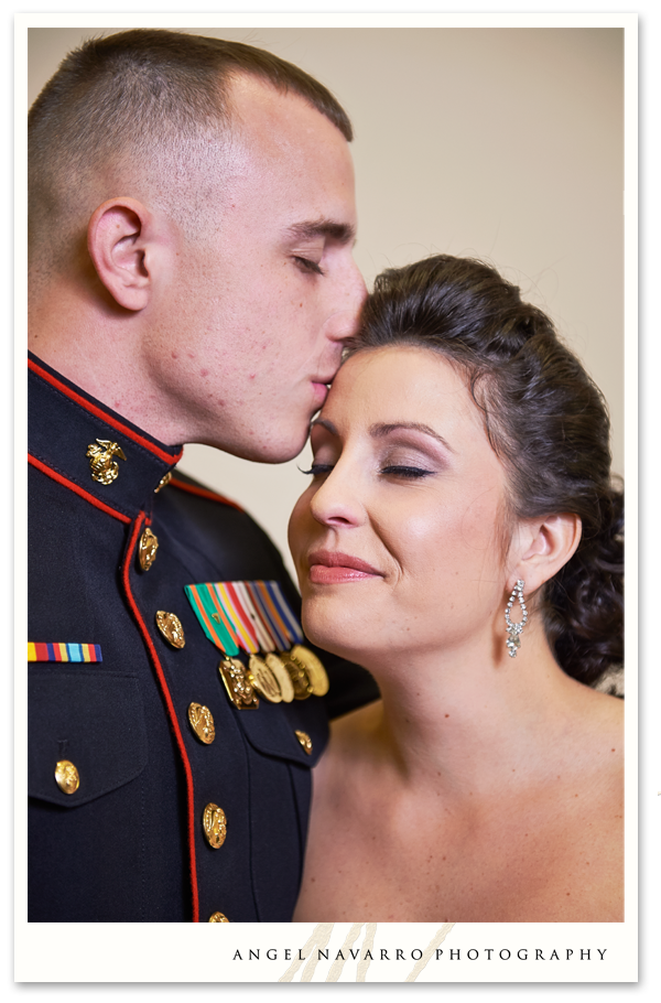 Military brother kisses sister on forehead.