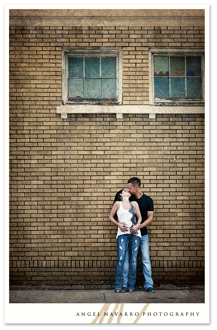 Tall building in background of couple's photo.