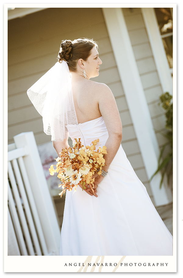 Bride holding bouquet behind her.