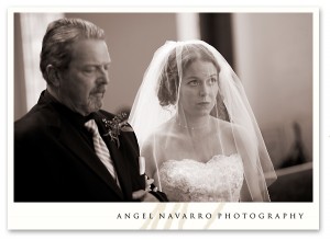 The father of the bride and his daughter walk to the altar.