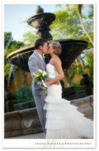 A wedding portrait by a fountain