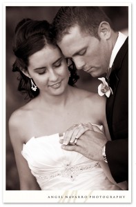 Bride and groom portrait looking at rings.