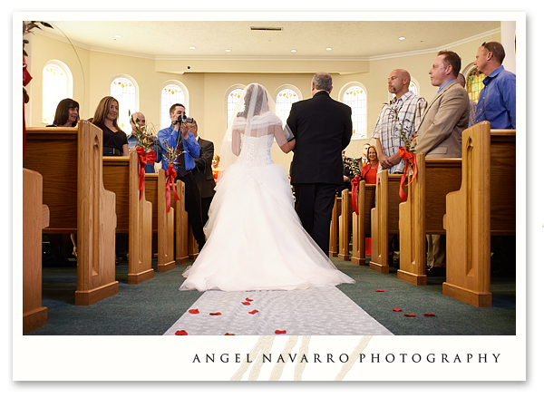 Beautiful photograph of the bride and her father as they walk down the isle towards the groom.