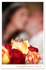 A creative picture of the wedding rings atop a wedding bouquet.