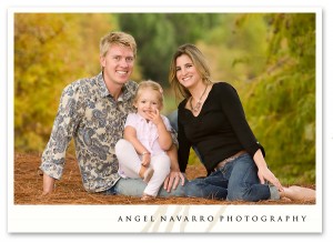 A family photo with beautiful background trees.