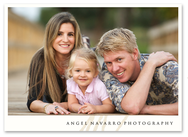 A family photo atop a scenic bridge.