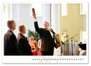 Groom holds up a symbolic gift at their wedding.