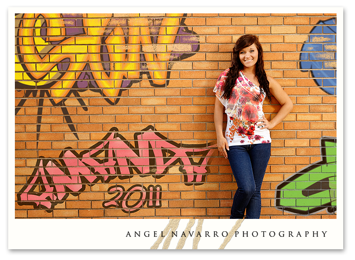 Senior portrait on graffiti wall.