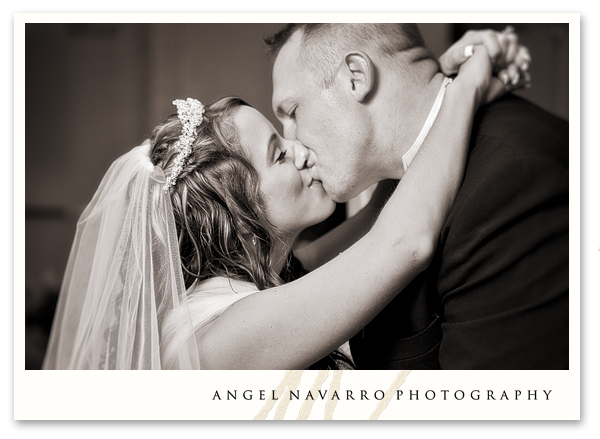 Bride and groom kiss during their first dance as husband and wife.