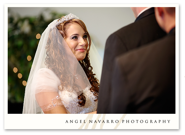 Bride filled with joy looks intently upon the groom.